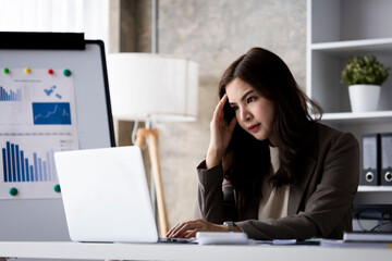 Young woman of working age, feeling various feelings that occur in the office, happy, stressed, relaxed in the company on a desk with equipment. Electronics are placed