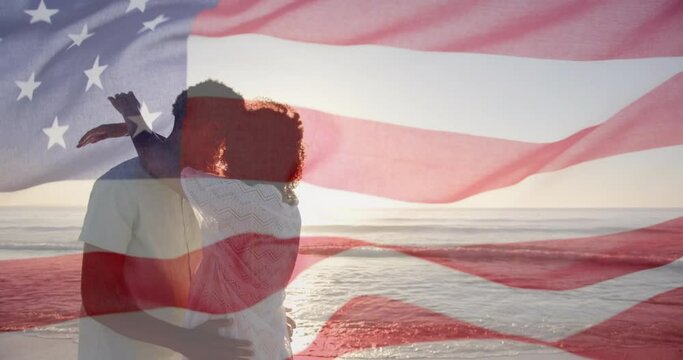 Animation of american flag over diverse couple embracing on sunny beach