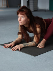 Power yoga for strong body. Beautiful young woman doing stretching exercises.