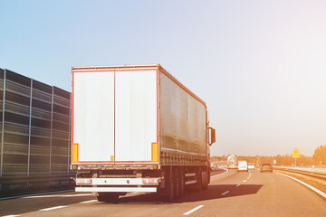Semi-trucks hauling cargo on highway at high speed