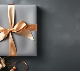 A gift wrapped in gold ribbon with a bow on a gray surface. Generative AI.