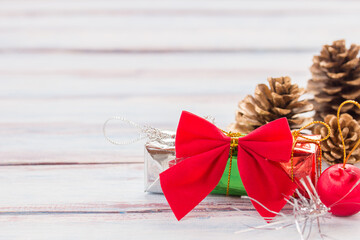 Red ribbon and christmas decoration on old grunge wooden table background.