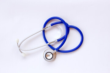 Top view blue stethoscope with shadow on white background.