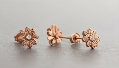 A Pair Of Rose Gold Stud Earrings Featuring Delica