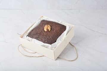 premium freshly baked dark cocoa chocolate brownie square birthday cake with walnut peanut almond...