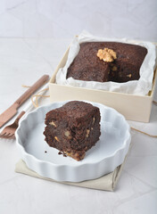premium freshly baked dark cocoa chocolate brownie square birthday cake with walnut peanut almond in wood bento box on white marble halal food gluten free sweet dessert menu for pastry cafe shop