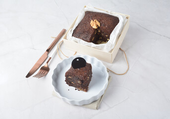 premium freshly baked dark cocoa chocolate brownie square birthday cake with walnut peanut almond in wood bento box on white marble halal food gluten free sweet dessert menu for pastry cafe shop