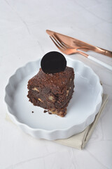 premium freshly baked dark cocoa chocolate brownie square birthday cake with walnut peanut almond in wood bento box on white marble halal food gluten free sweet dessert menu for pastry cafe shop