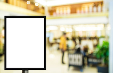 Blank advertising billboard or wide screen television with blurred shopping mall background