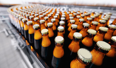 Automated modern beer bottling factory line with rows of filled bottles