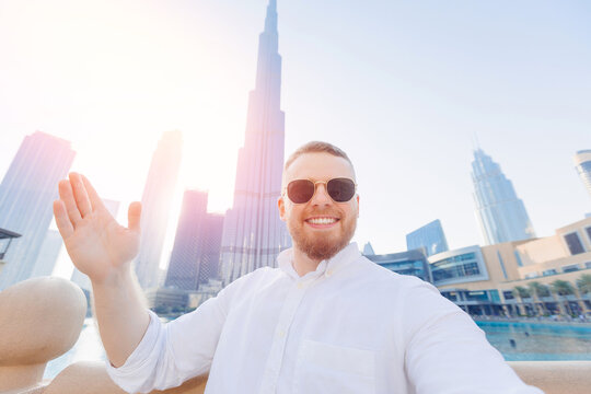 UAE business tourism for cryptocurrency, Selfie photo of young crypto businessman smile man tourist on background skyscrapers in Dubai