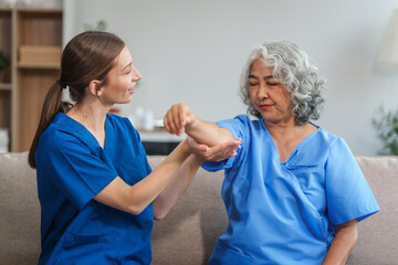 A young Caucasian physical therapist and an elderly Asian woman in her 60s attended a physical...