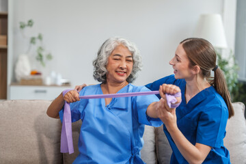 A young Caucasian physical therapist and an elderly Asian woman in her 60s attended a physical therapy course regarding muscle pain and muscle weakness. and heel pain with elastic bands