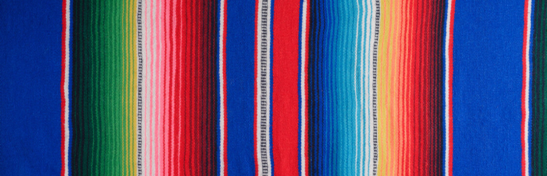 Cinco de Mayo background. Serape, colorful blanket with stripes. Banner.
