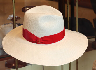 Elegant white fedora hat with red ribbon