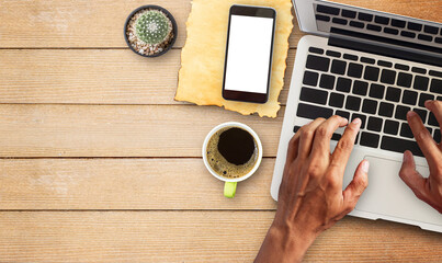 Hand working laptop comuter with cup of coffee