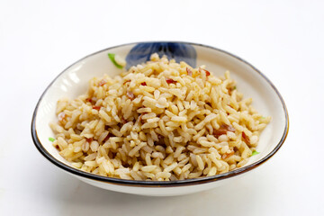 Cooked brown rice on white background.