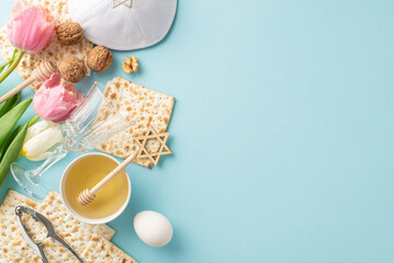 Passover composition with top view of matza, a goblet, walnuts, an egg, honey with a spoon, a...