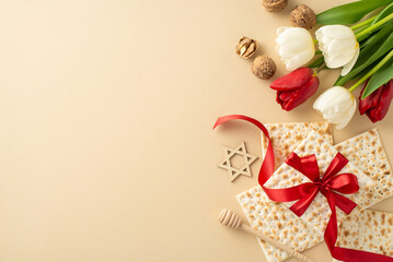 Chic Passover setup: overhead shot featuring ribbon-tied matzah, walnuts, honey spoon, star of David, and bouquet of tulips on a soft beige backdrop, space for text or advertisement