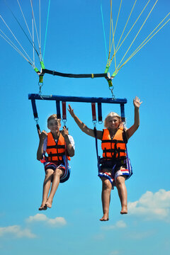 Mother and son parasailing over the Mediterranean Sea, T&uuml;rkiye in mid-summer. Family and summer vacation concept