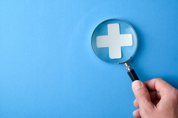 Medical information and examination with magnifying cross with magnifying glass
