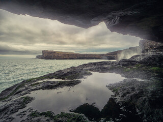 Rough nature of Aran islands with ocean and rock cliffs. Low cloudy sky. Dark and moody feel....