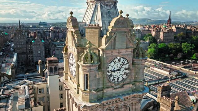 Aerial view of 5-star hotel, city view of old buildings in Edinburgh, Scotland. Luxury hotel and landmark clock tower, a symbol of its city. Victorian architecture in Scotland.