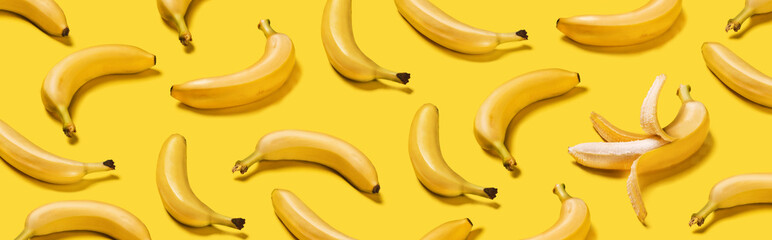 Banner bananas with hard shadows pattern on yellow background