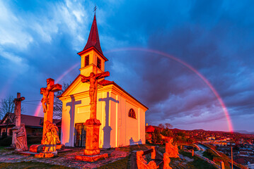 The Chapel of Saint Thomas Becket in Szent Tamas lighten by a strong sunlight with a rainbow behind...