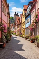 Historic cobblestone alley with blooming flowers - obrazy, fototapety, plakaty
