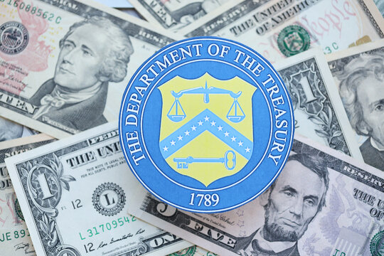 KYIV, UKRAINE - MARCH 9, 2024 US The Department of the Treasury seal on many US dollar bills close up