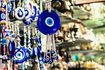 Turkish evil eye (Nazar boncugu) amulets glisten, a fusion of deep blues and whites, cultural beliefs and aesthetics of Turkey. Street shop. Copy space. Traditional souvenir of Turkiye (Turkey)