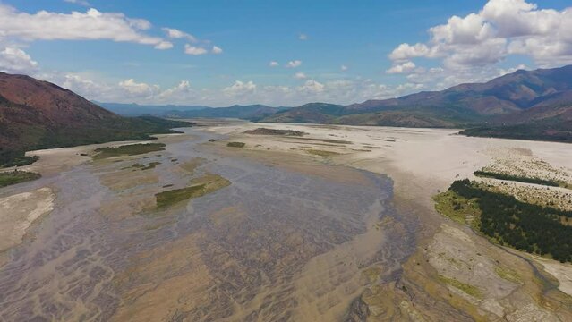 Aerial view of shallow river in the dry season in a mountain valley. Bucao river. Luzon, Philippines.