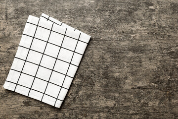 top view with white empty kitchen napkin isolated on table background. Folded cloth for mockup with...