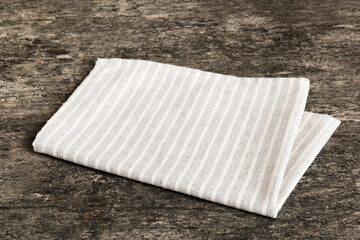 top view with gray kitchen napkin isolated on table background. Folded cloth for mockup with copy space, Flat lay. Minimal style