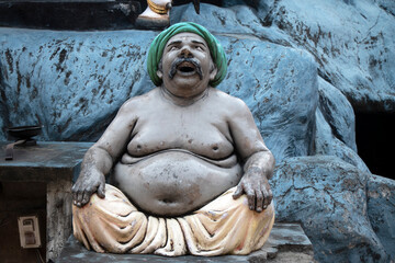 statue of a laughing fat man - obrazy, fototapety, plakaty