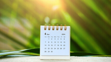 Desk calendar for April 2024 with sunlight in the garden