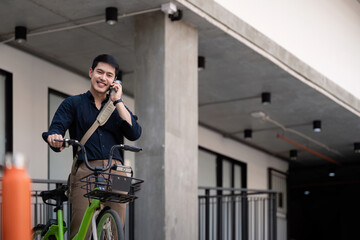 Fototapeta premium Businessman and bicycle in city to work with eco friendly transport. bike and happy businessman professional talking, speaking and telephone discussion while on in urban street