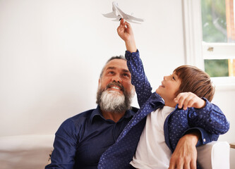 Grandpa, kid and playing with toy airplane in home, love and bonding together on vacation in living room. Happy family, boy and grandfather with jet game in lounge, relax and care on school holiday