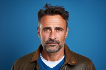 Portrait of a handsome middle-aged man, over blue background