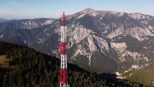Drone flying towards and circling around a Radio tower on the top of Rax mountain