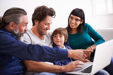 Family, laptop and learning or streaming on sofa, smile and bonding in living room. Video call, internet and chat with grandfather pointing, parents and young boy for communication online in home