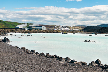 Hot geothermal lagoon with power plant on background in Iceland