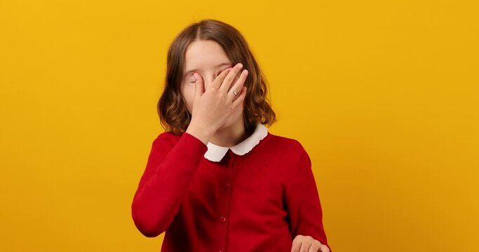 Teenage Schoolgirl Squinting to See Clearly Against Yellow Background