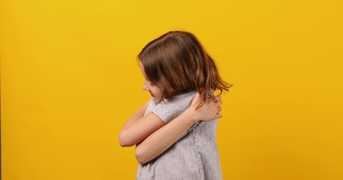 Schoolgirl With Closed Eyes Hugging Herself