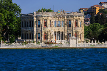 Fototapeta premium View from the water of the Bosphorus Strait to ancient palaces and buildings. Public place on the street of Istanbul, Türkiye.