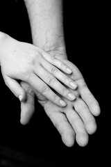 old and young hands together