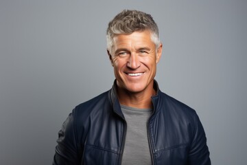 Handsome middle aged man with grey hair. Studio shot.