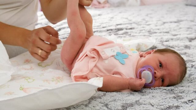Mom changes baby's diaper. selective focus.