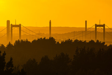 Sun Setting Over Bridge in Distance